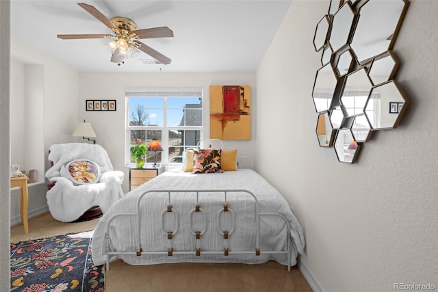 bedroom with baseboards, carpet floors, and a ceiling fan