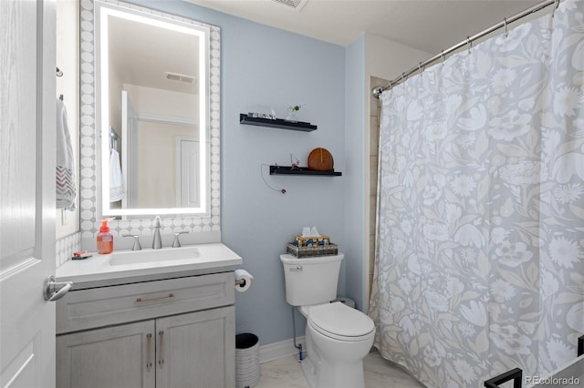 bathroom featuring visible vents, toilet, marble finish floor, baseboards, and vanity