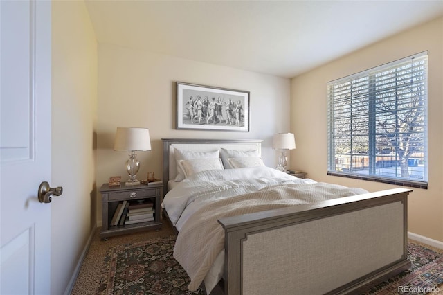 bedroom featuring dark carpet