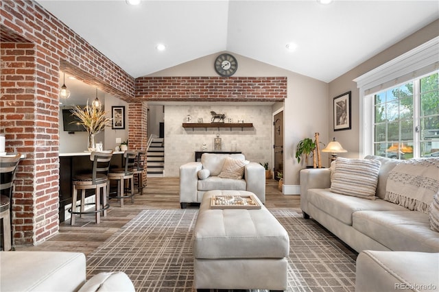 living room featuring vaulted ceiling, wood finished floors, recessed lighting, and baseboards