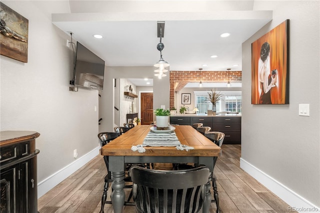 dining space featuring baseboards, light wood-type flooring, and recessed lighting