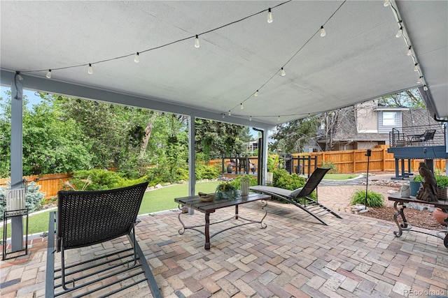 view of patio featuring fence