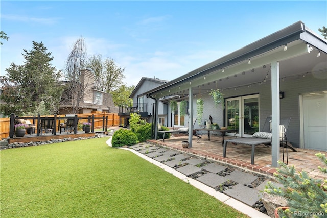 view of yard with a patio and french doors