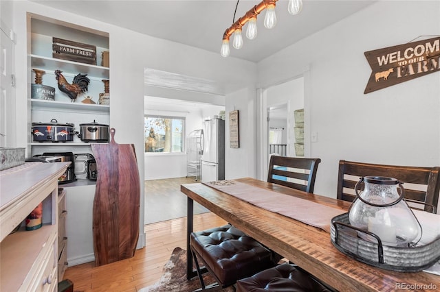 dining area featuring light wood-type flooring