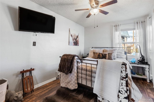 interior space featuring ceiling fan, dark hardwood / wood-style flooring, and a textured ceiling