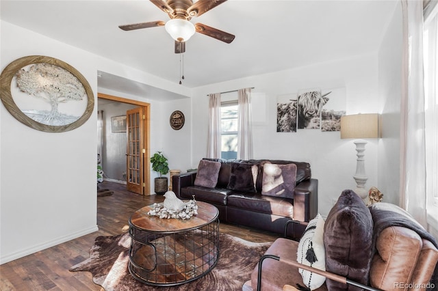 living room with ceiling fan and dark hardwood / wood-style flooring