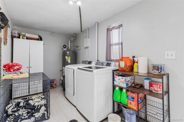 laundry area featuring water heater and washer and dryer