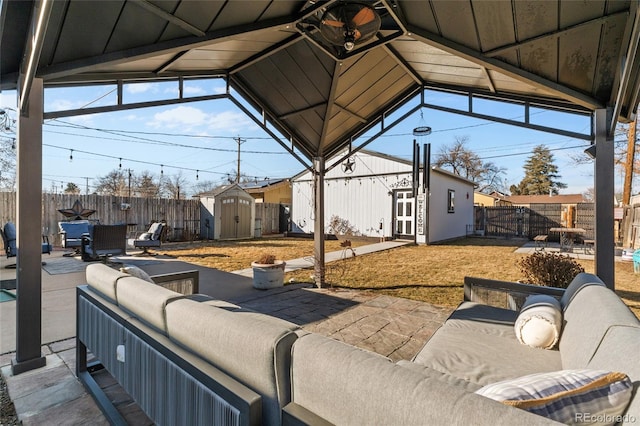 view of patio with a gazebo, a storage shed, and outdoor lounge area