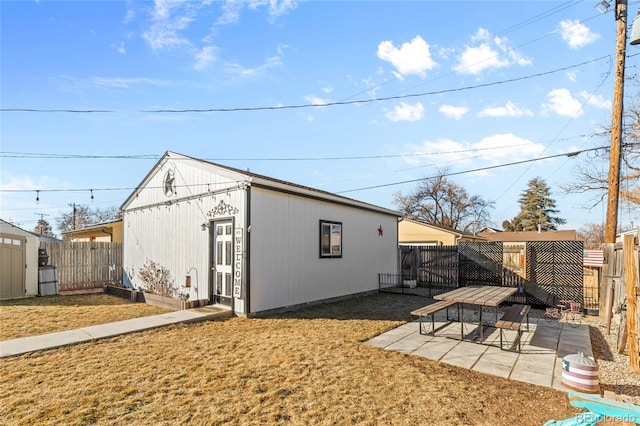 exterior space with a yard, an outdoor structure, and a patio area