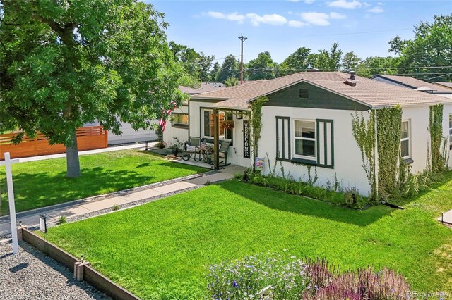4389 S Sherman St, Englewood, CO 80113 - view of front facade with stucco siding, a front lawn, and roof with shingles