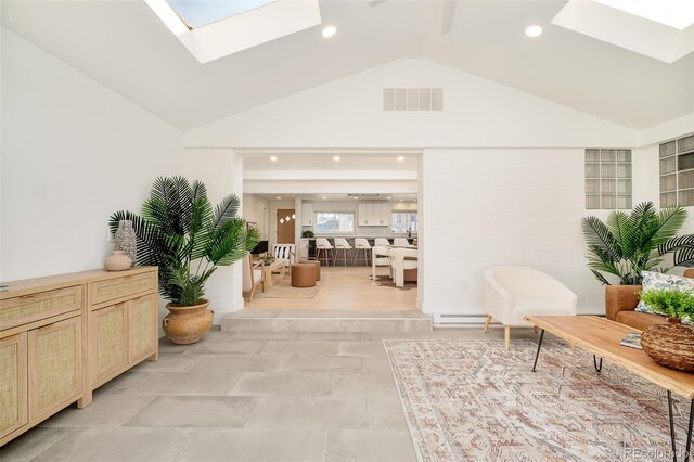 interior space with a skylight, high vaulted ceiling, recessed lighting, and visible vents