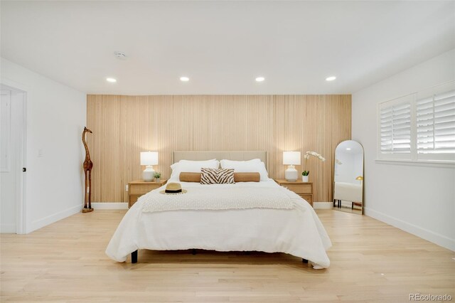 bedroom featuring baseboards, recessed lighting, and light wood finished floors