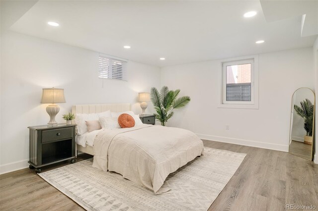 bedroom featuring baseboards, recessed lighting, and wood finished floors