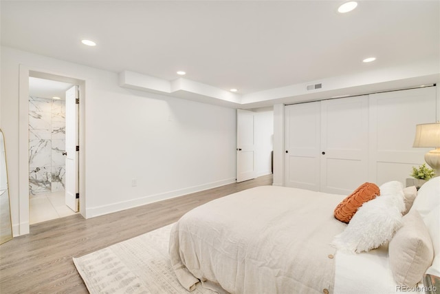 621 S Harrison Ln, Denver, CO 80209 - bedroom with recessed lighting, light wood-style floors, ensuite bathroom, baseboards, and a closet
