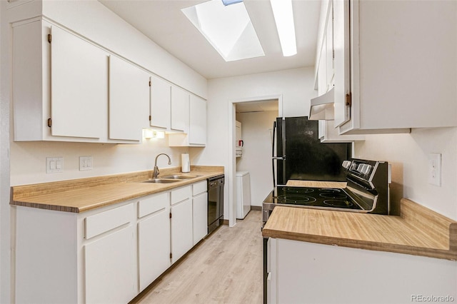 kitchen with white cabinetry, black appliances, under cabinet range hood, and a sink