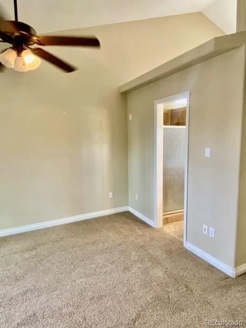 spare room featuring light carpet, ceiling fan, and lofted ceiling