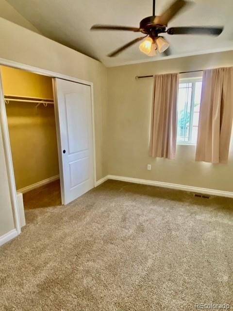 unfurnished bedroom featuring carpet floors, a closet, and ceiling fan