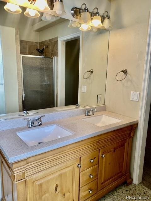 bathroom with a shower with door and vanity