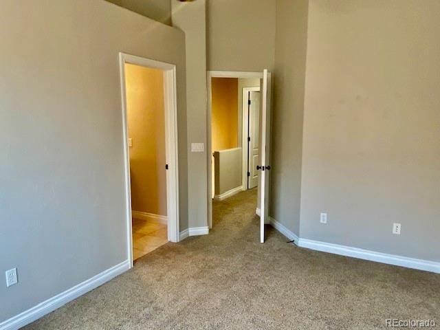 unfurnished bedroom with light colored carpet