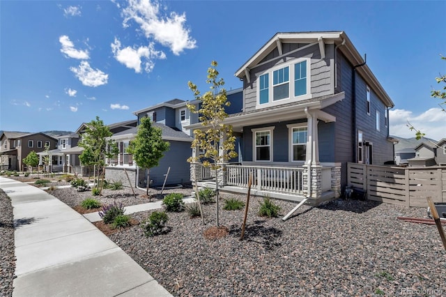 8049 Monte Vista Cir, Littleton, CO 80125 - craftsman-style home featuring a porch, fence, and a residential view