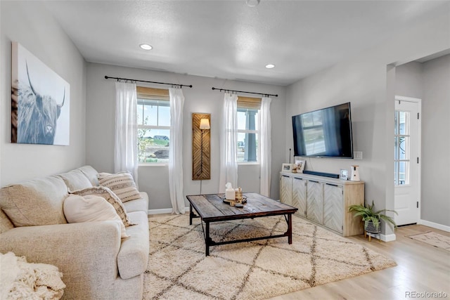 8049 Monte Vista Cir, Littleton, CO 80125 - living room with healthy amount of natural light, baseboards, light wood-style floors, and recessed lighting