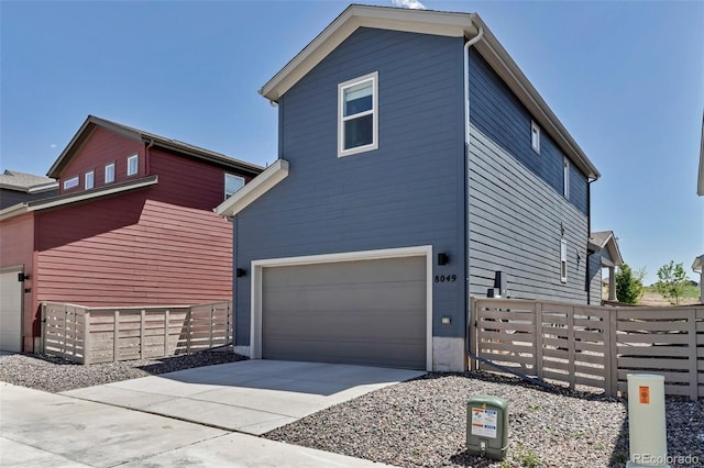 8049 Monte Vista Cir, Littleton, CO 80125 - view of property exterior featuring a garage, fence, and concrete driveway