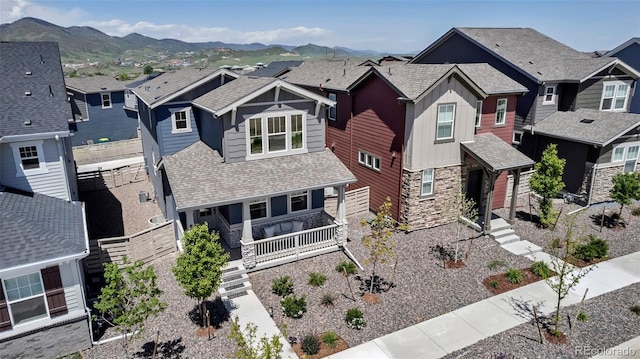 8049 Monte Vista Cir, Littleton, CO 80125 - craftsman inspired home featuring board and batten siding, a residential view, covered porch, stone siding, and a mountain view