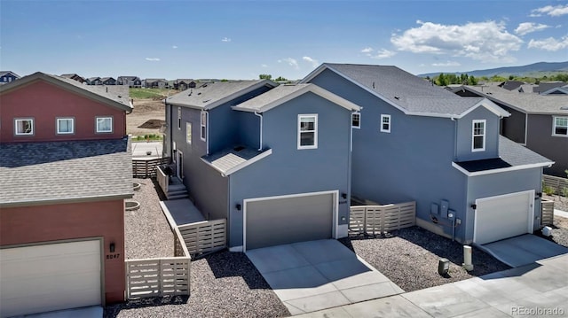8049 Monte Vista Cir, Littleton, CO 80125 - view of front facade featuring stucco siding, an attached garage, driveway, and a residential view