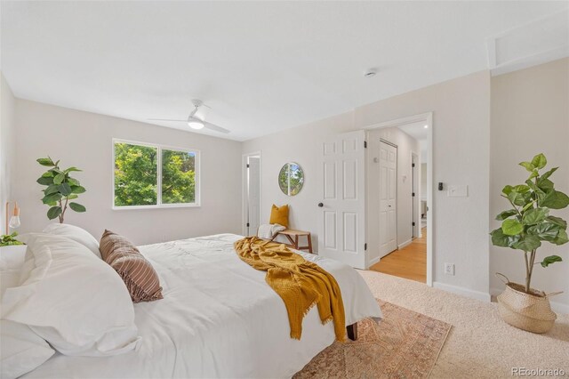 1205 W 101st Ave, Northglenn, CO 80260 - bedroom with light carpet, a ceiling fan, and baseboards
