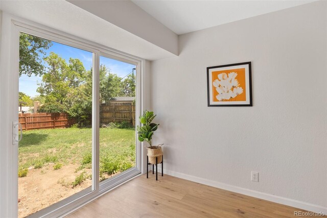 1205 W 101st Ave, Northglenn, CO 80260 - doorway to outside featuring wood finished floors and baseboards