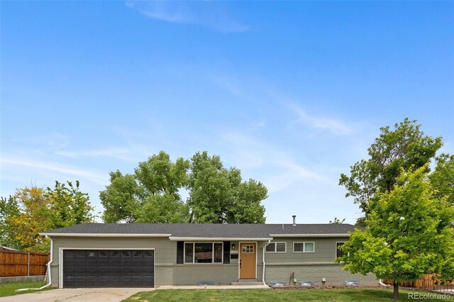 1205 W 101st Ave, Northglenn, CO 80260 - ranch-style home featuring a garage, brick siding, and driveway