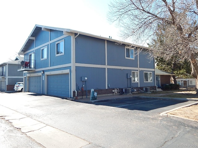 view of front of property featuring an attached garage and central AC unit