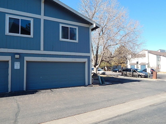 view of home's exterior featuring a garage and a residential view