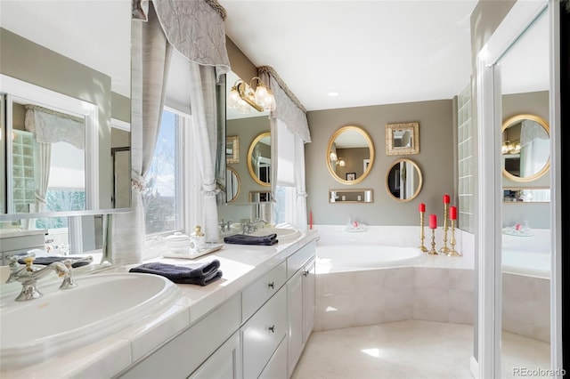 bathroom featuring double vanity, a garden tub, and a sink