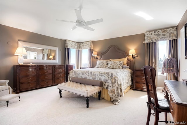 bedroom with a ceiling fan and light carpet