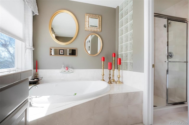 full bath featuring a stall shower and a garden tub