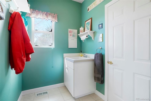 bathroom with visible vents, baseboards, vanity, and tile patterned flooring