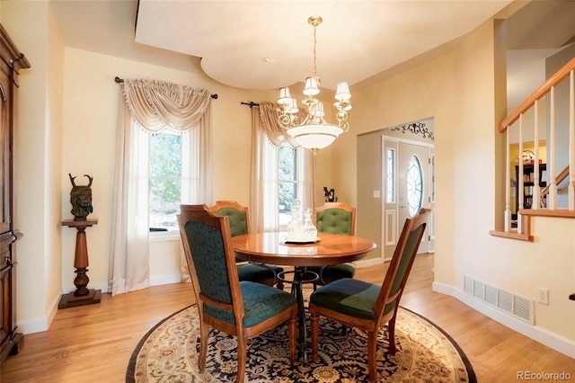 dining space featuring plenty of natural light, visible vents, and light wood finished floors