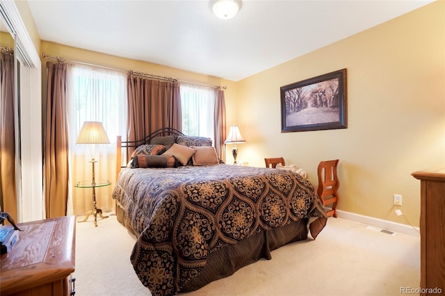 carpeted bedroom featuring visible vents and baseboards