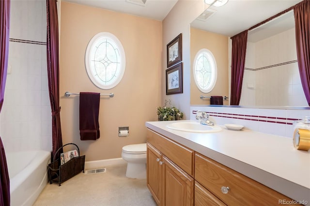 bathroom with visible vents, toilet, a healthy amount of sunlight, and vanity