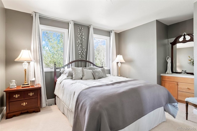 bedroom featuring light carpet