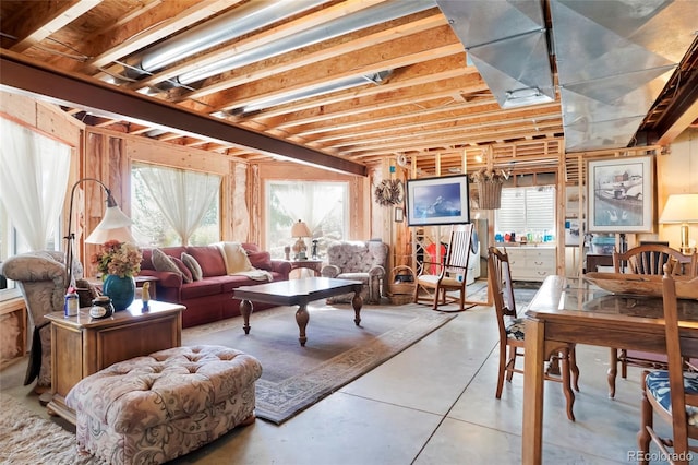 living area featuring concrete flooring and a healthy amount of sunlight