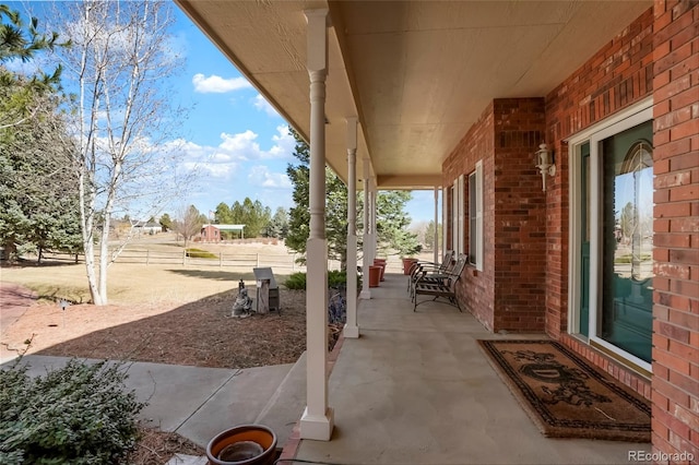view of patio / terrace with covered porch and fence