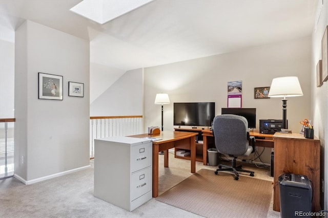 office featuring baseboards, light colored carpet, and a skylight