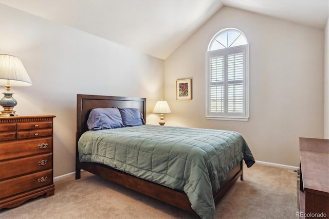 carpeted bedroom featuring baseboards and vaulted ceiling