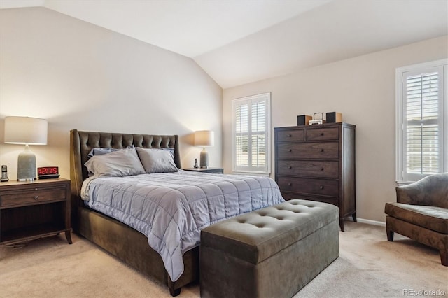 bedroom with baseboards, lofted ceiling, and light colored carpet