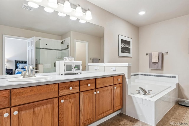 bathroom with tile patterned floors, visible vents, a shower stall, a bath, and vanity