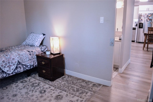 650 S Clinton St Unit 2A, Denver, CO 80247 - bedroom featuring stainless steel fridge and light wood-style flooring