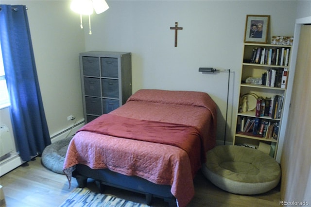 650 S Clinton St Unit 2A, Denver, CO 80247 - bedroom featuring wood finished floors and a baseboard radiator
