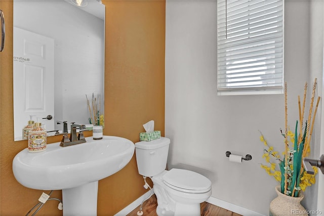 21900 E 46th Pl, Aurora, CO 80019 - half bathroom with baseboards, toilet, wood finished floors, and a sink